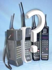 four analogue mobile phones and a question mark